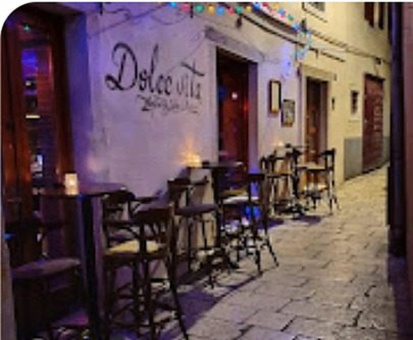 The entrance of Dolce Vita Caffe on M. Dalmatinske in Zadar, with tables set out in the alley