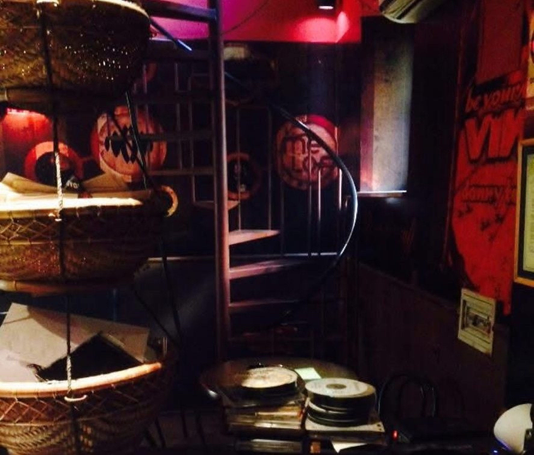 DJ booth with turntables beside the spiral staircase