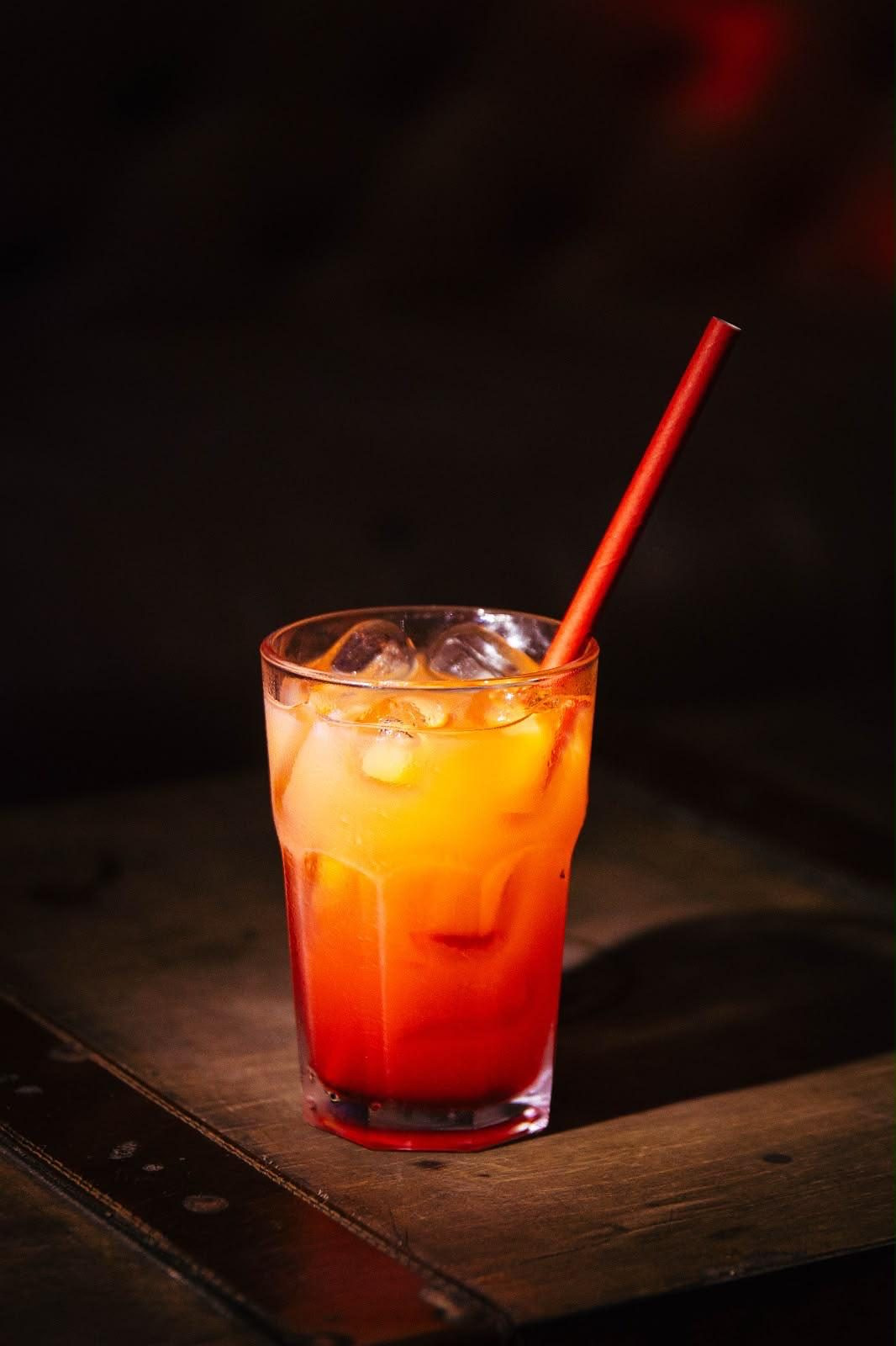 Layered orange cocktail on the bar